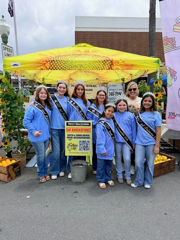 Volunteers gathered around the Protect Rural Escondido outreach booth at the Escondido Street Fair.